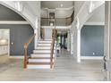 Spacious foyer with high ceilings, wood staircase, and views of the open-concept layout at 1777 Water Springs Way, Dacula, GA 30019