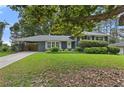 Beautifully landscaped front yard with a brick house and covered side entrance at 2416 Elmwood Se Cir, Atlanta, GA 30339