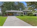 The home has an inviting exterior with well-manicured lawn and a covered parking area at 2416 Elmwood Se Cir, Atlanta, GA 30339