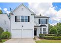 Traditional two-story home with a manicured lawn and front-entry two-car garage at 3710 Ridgefair Dr, Cumming, GA 30040