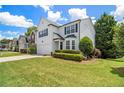 Two-story home with black shutters and lush landscaping on a sunny day at 3710 Ridgefair Dr, Cumming, GA 30040