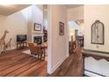 Bright living room with wood floors, fireplace, and an open layout leading to the dining area at 510 Independence Way, Roswell, GA 30075