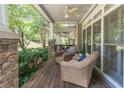 Relaxing porch with comfortable seating, ceiling fan and stone pillars creating an inviting outdoor space at 510 Independence Way, Roswell, GA 30075