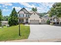 Attractive two-story home with a well-maintained lawn, basketball hoop, and a spacious driveway at 5605 Miners Rdg, Cumming, GA 30028