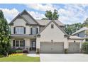 Beautiful two-story home with a two-car garage, and a welcoming front porch, perfect for relaxation at 5605 Miners Rdg, Cumming, GA 30028