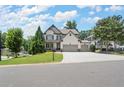 Inviting two-story home with a lush green lawn, a basketball hoop, and a spacious driveway at 5605 Miners Rdg, Cumming, GA 30028