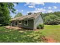 View of the home's backyard showcasing a grassy yard and rear exterior, perfect for outdoor activities at 1050 Chapman Circle Cir, Stone Mountain, GA 30088