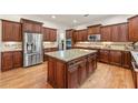 Gourmet kitchen showcasing stainless steel appliances, custom cabinets, and a granite island at 2317 Whiting Bay Courts Nw, Kennesaw, GA 30152