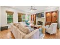 Inviting living room boasts a stone fireplace, built-in shelving, and natural light at 2317 Whiting Bay Courts Nw, Kennesaw, GA 30152
