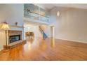 Open living room with hardwood floors, fireplace, and soaring vaulted ceilings at 502 Brookline Pl, Mcdonough, GA 30252