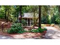 Charming house with a covered porch and well-maintained landscaping and wooded surroundings at 203 Cedar Creek Ct, Acworth, GA 30101