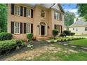 Beautiful brick home with a well-maintained lawn and classic architectural details at 615 Willowbrook Run, Johns Creek, GA 30022