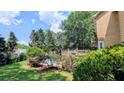 Scenic backyard featuring a wooden deck and swimming pool surrounded by mature trees and lush greenery at 75 Maygold St, Mcdonough, GA 30253