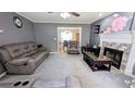Cozy living room with gray walls, fireplace, and comfortable seating arrangement at 75 Maygold St, Mcdonough, GA 30253