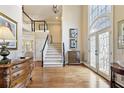 Elegant foyer with hardwood floors, grand staircase, and a striking arched window at 1111 Waterford Green Pt, Marietta, GA 30068
