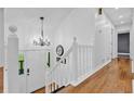 Bright foyer with hardwood floors, white staircase, a decorative chandelier and front door with sidelights at 3860 Paint Cir, Douglasville, GA 30135
