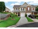 A well maintained townhome with a charming front yard, attached garage, and inviting facade at 303 Fox Overlook, Woodstock, GA 30188