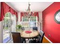 Bright dining room with chandelier and sliding glass doors leading to a patio at 3198 Liberty Commons Dr, Kennesaw, GA 30144