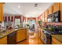 Open kitchen with wooden cabinets, modern appliances, and connection to a dining area at 3198 Liberty Commons Dr, Kennesaw, GA 30144