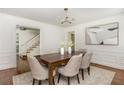 Bright dining room featuring a modern chandelier, art, and an opening to the stairwell at 799 Birds Se Ml, Marietta, GA 30067