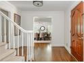 Bright foyer with hardwood floors, white trim, staircase, and a view into the dining room at 799 Birds Se Ml, Marietta, GA 30067