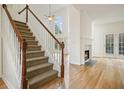 Bright home entryway with staircase, hardwood floors, fireplace, and lots of natural light at 1971 Wellesley Trce, Dunwoody, GA 30338