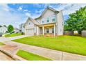 Inviting two-story home with a lush green lawn, showcasing the home's attractive exterior at 2102 Black Pebble Cir, Buford, GA 30519