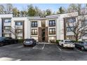 Apartment building featuring assigned parking spaces and manicured landscaping at 1445 Monroe Ne Dr # F12, Atlanta, GA 30324