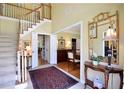 Inviting foyer showcases staircase and entry to dining room with beautiful decor at 340 Channings Lake Dr, Lawrenceville, GA 30043