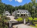 Beautiful home with a gated entrance, lush green lawn and four-car garage, and detached additional garage at 504 Trinity Church Rd, Canton, GA 30115