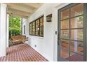 Inviting front porch with classic brick flooring and a charming wooden swing at 118 Chelsea Dr, Decatur, GA 30030