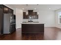 Modern kitchen boasts stainless steel appliances, center island, and granite countertops at 2231 Bedell Dr, Conyers, GA 30094