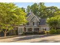 Charming two-story home with a stone and stucco exterior, complemented by mature trees at 4789 Crest Park Ln, Marietta, GA 30068