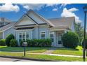 Inviting blue home with lush green lawn, mature hedges, and a quaint covered entryway at 903 Duncan Ter, Canton, GA 30115