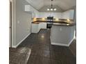 Modern kitchen featuring white cabinets, dark granite countertops and stainless steel appliances at 12 Barrington Ct, Sharpsburg, GA 30277
