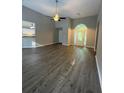 Bright living room featuring vaulted ceiling, ceiling fan and modern hardwood floors at 12 Barrington Ct, Sharpsburg, GA 30277