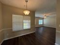 Dining area featuring wood floors and views into living room at 425 Bell Flower Trl, Locust Grove, GA 30248