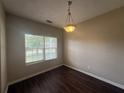 Dining area with wood floors and natural light from a window at 425 Bell Flower Trl, Locust Grove, GA 30248