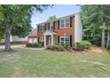Beautiful red brick home with black shutters, complemented by a lush green lawn at 2683 Berry Ridge Ct, Buford, GA 30519