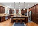 Spacious kitchen with dark wood cabinets, granite countertops, and stainless steel appliances at 2283 Falmouth Se Ct # 22, Smyrna, GA 30080