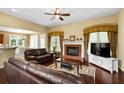 Comfortable living room with a brick fireplace, hardwood floors, and large windows that provide natural light at 3053 Ramsey Pl, Marietta, GA 30062