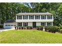 Classic two-story home with navy shutters, green lawn and a well manicured front yard at 321 Crabtree Court, Marietta, GA 30068
