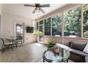 Cozy sunroom with tile floors, a ceiling fan, and a wall of windows at 35 Westfair Ct, Atlanta, GA 30328