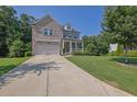 Charming brick home featuring an inviting front porch and well-maintained lawn, surrounded by mature trees at 4445 Hager Ct, Cumming, GA 30040