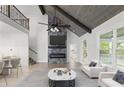 Open-concept living room featuring high ceilings, a stone fireplace, and stylish furnishings at 474 Haley Se St, Marietta, GA 30060