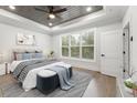 Bright and airy main bedroom with tray ceiling, a large window, and neutral decor at 474 Haley Se St, Marietta, GA 30060