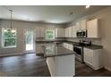 Modern kitchen with stainless steel appliances, granite countertops, and a central island at 15 Barton Ln, Covington, GA 30016