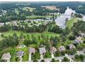 Areal view of neighborhood with mature trees, some homes featuring in-ground pools, and nearby lake at 3011 Stillwater Dr, Villa Rica, GA 30180
