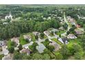 Aerial view of neighborhood with mature trees, some homes featuring in-ground pools, and nearby lake at 3011 Stillwater Dr, Villa Rica, GA 30180