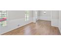 Bright living room with light wood floors and white wainscoting offers a clean, inviting space at 1260 White Oak Se St, Conyers, GA 30013